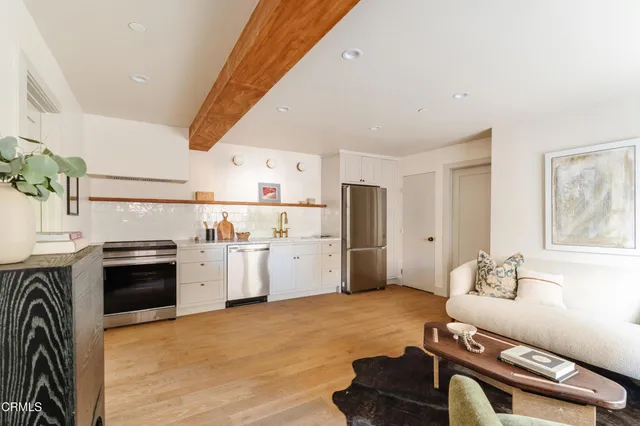 a kitchen with stainless steel appliances kitchen island granite countertop a refrigerator and a stove top oven