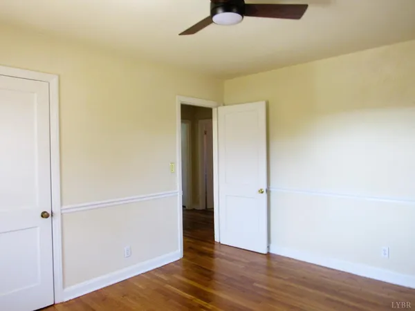 an empty room with wooden floor