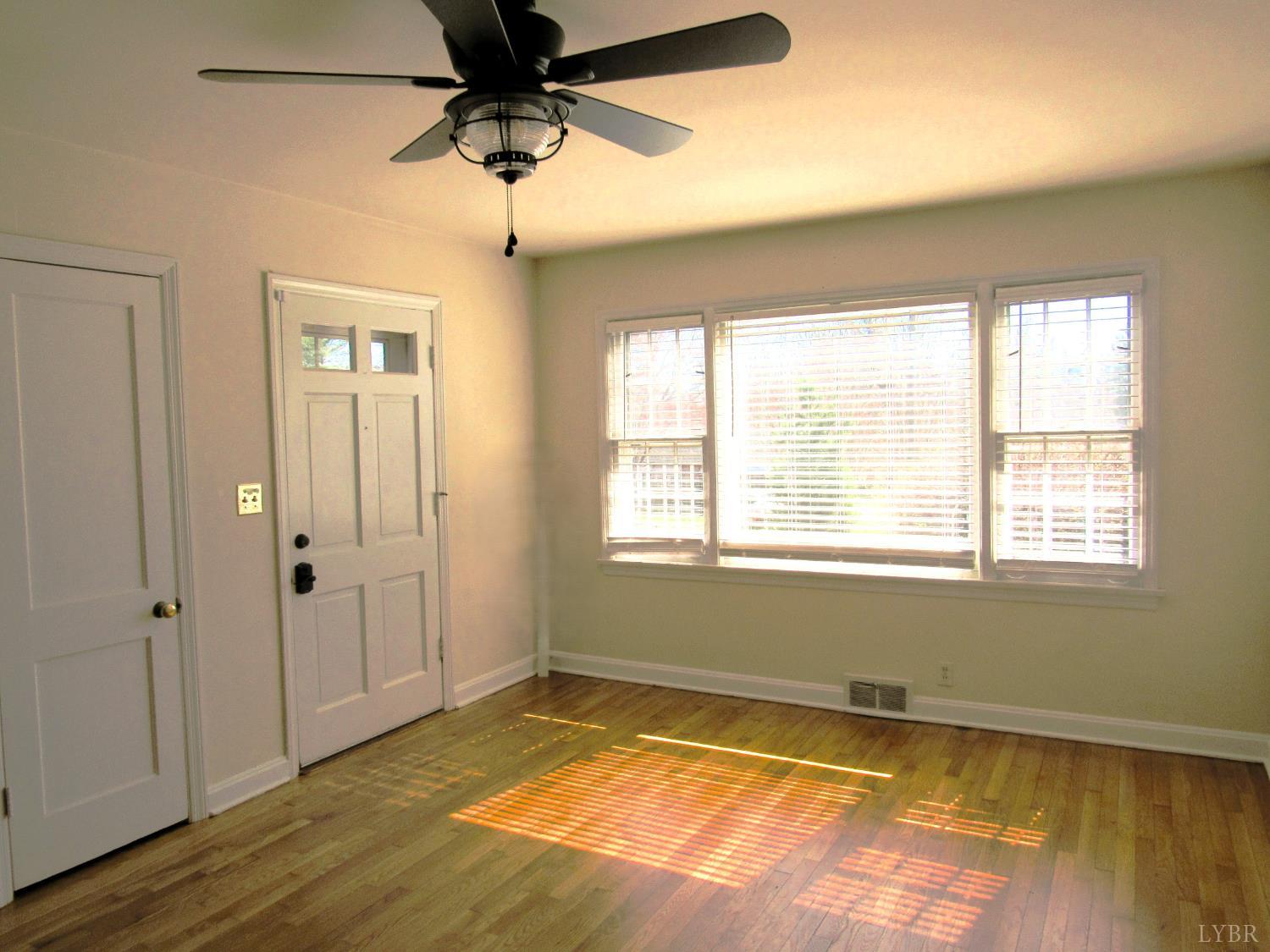 144 Maple Lane Amherst, VA 24521 - Photo 5 of 29 a view of an empty room with a window and wooden floor