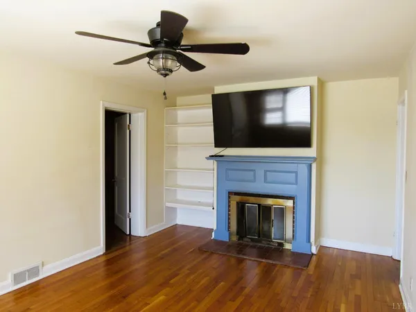 a living room with a fireplace and a flat screen tv