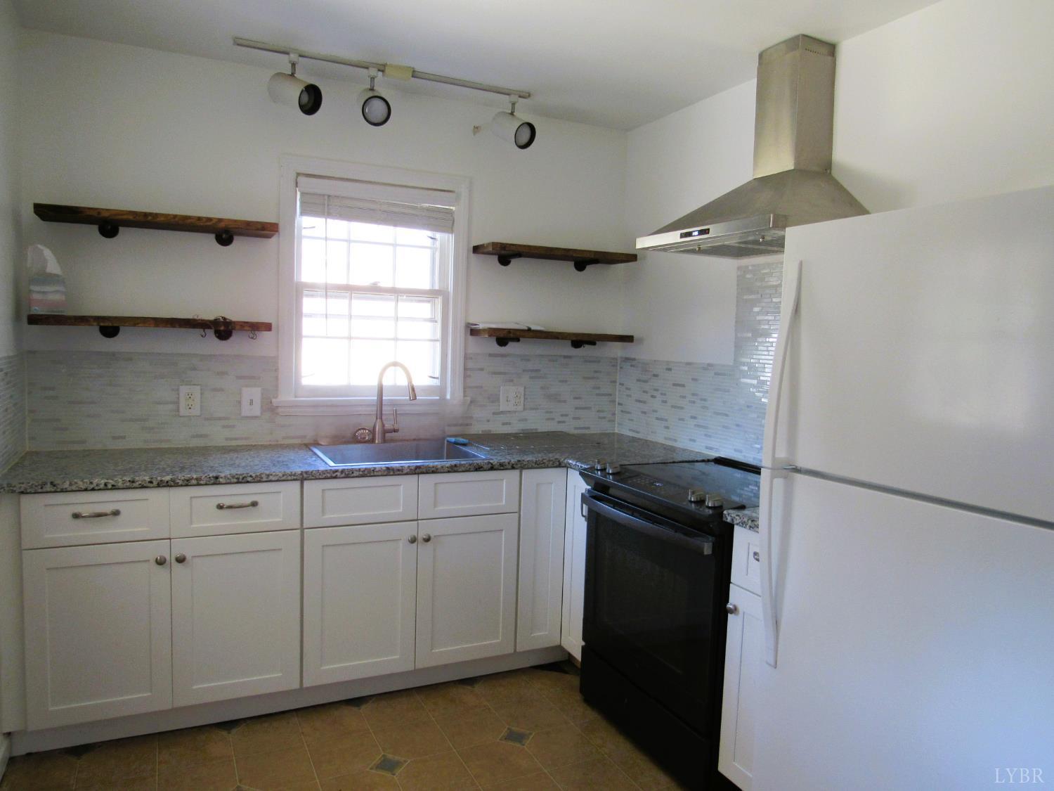 144 Maple Lane Amherst, VA 24521 - Photo 8 of 29 a kitchen with granite countertop a sink stainless steel appliances and cabinets