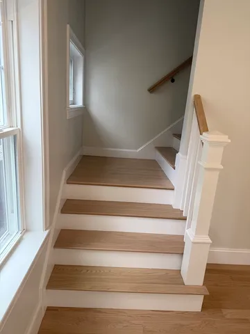 a view of staircase with white walls and a window