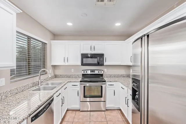 a kitchen with a stove a sink and a refrigerator