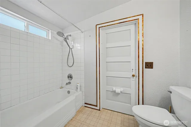 a bathroom with a toilet and shower