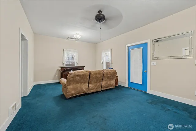 a bedroom with a bed and a ceiling fan