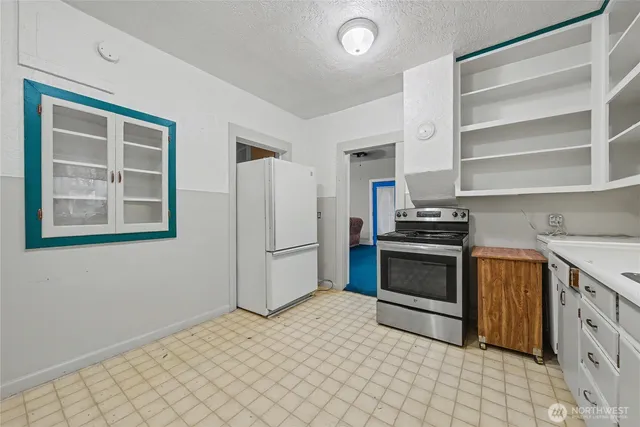 a kitchen with a refrigerator stove and cabinets