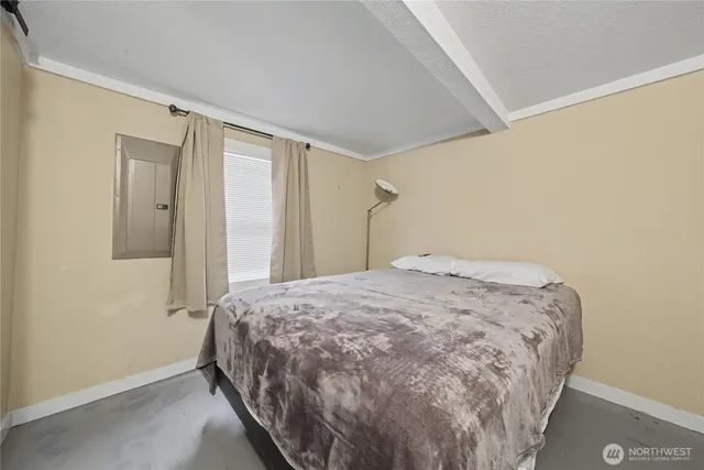 a bedroom with a bed and a window