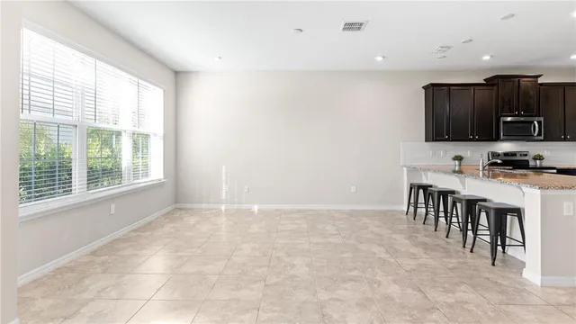 a kitchen with a sink a microwave and cabinets