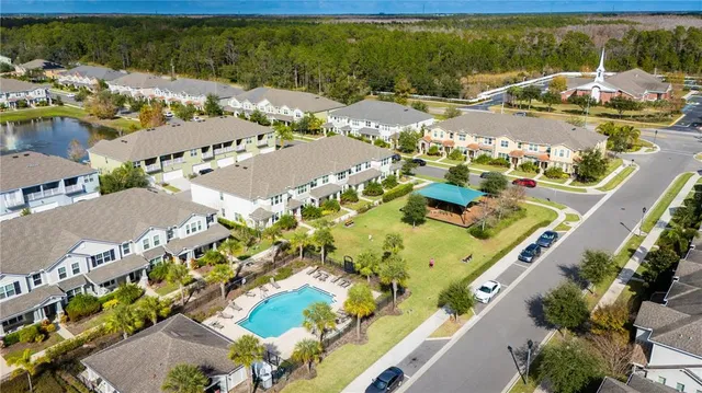 an aerial view of residential houses with outdoor space