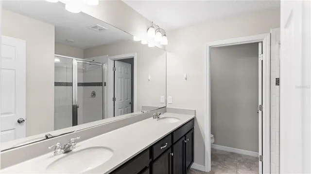 a bathroom with a sink double vanity and a mirror