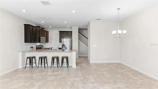 a large kitchen with a large counter top appliances and cabinets