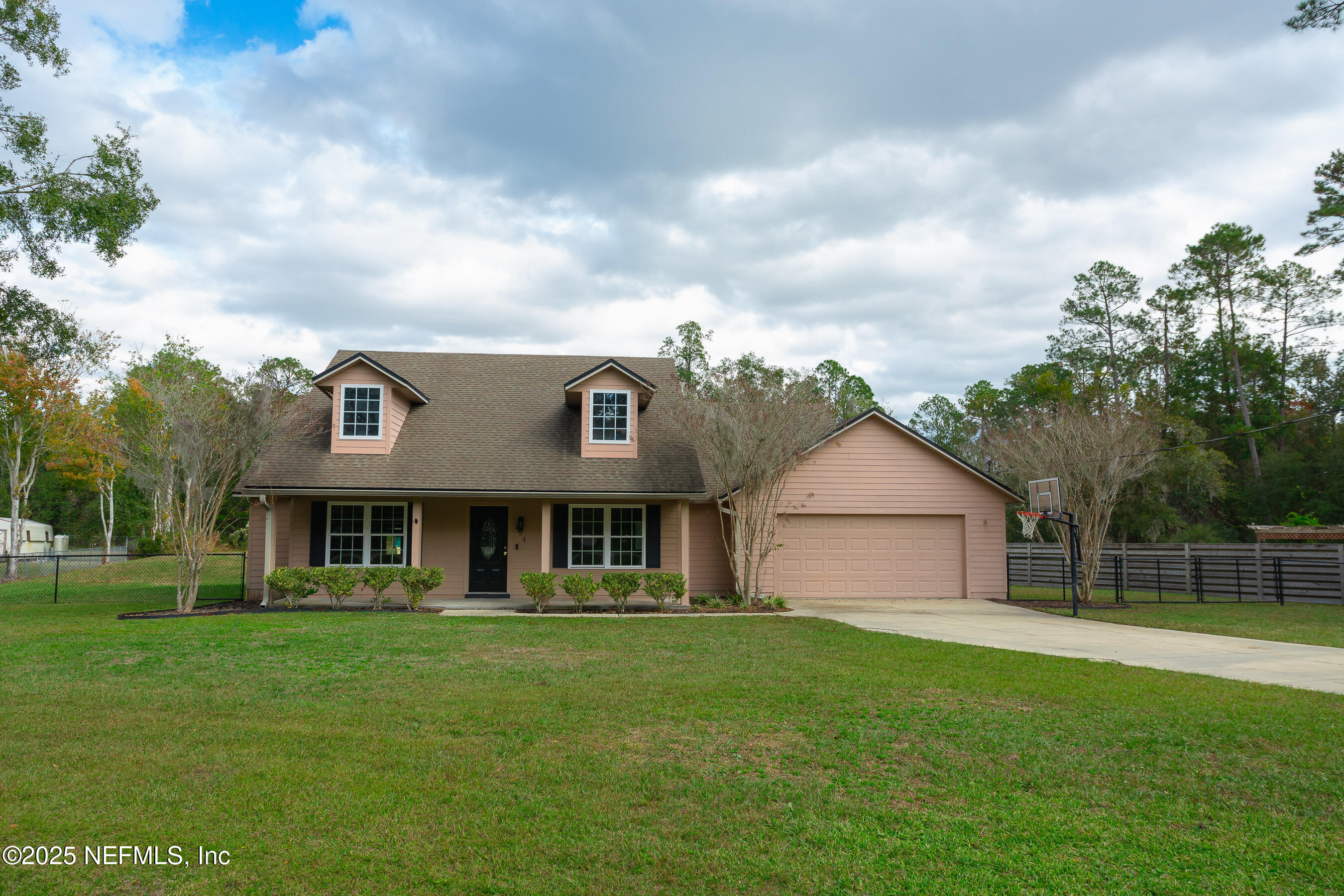 a view of house with yard and green space