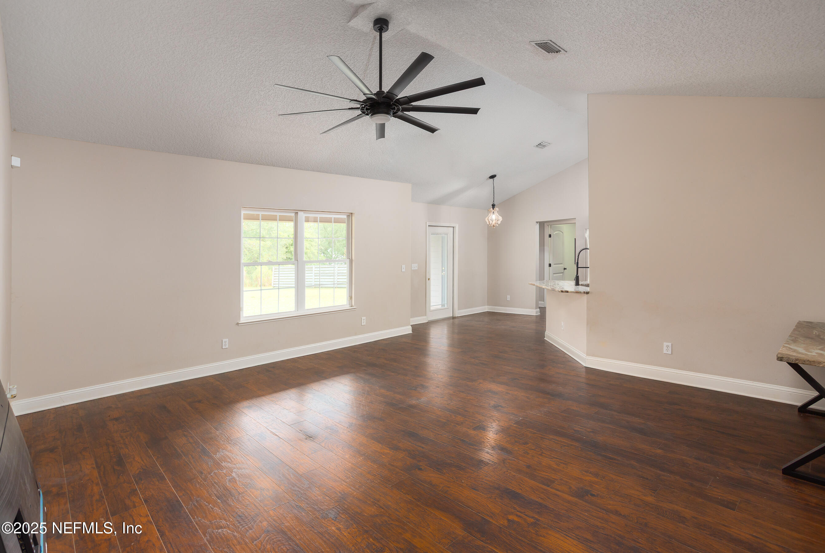 194 Horseman Club Road Palatka, FL 32177 - Photo 13 of 27 a view of an empty room with wooden floor and a window