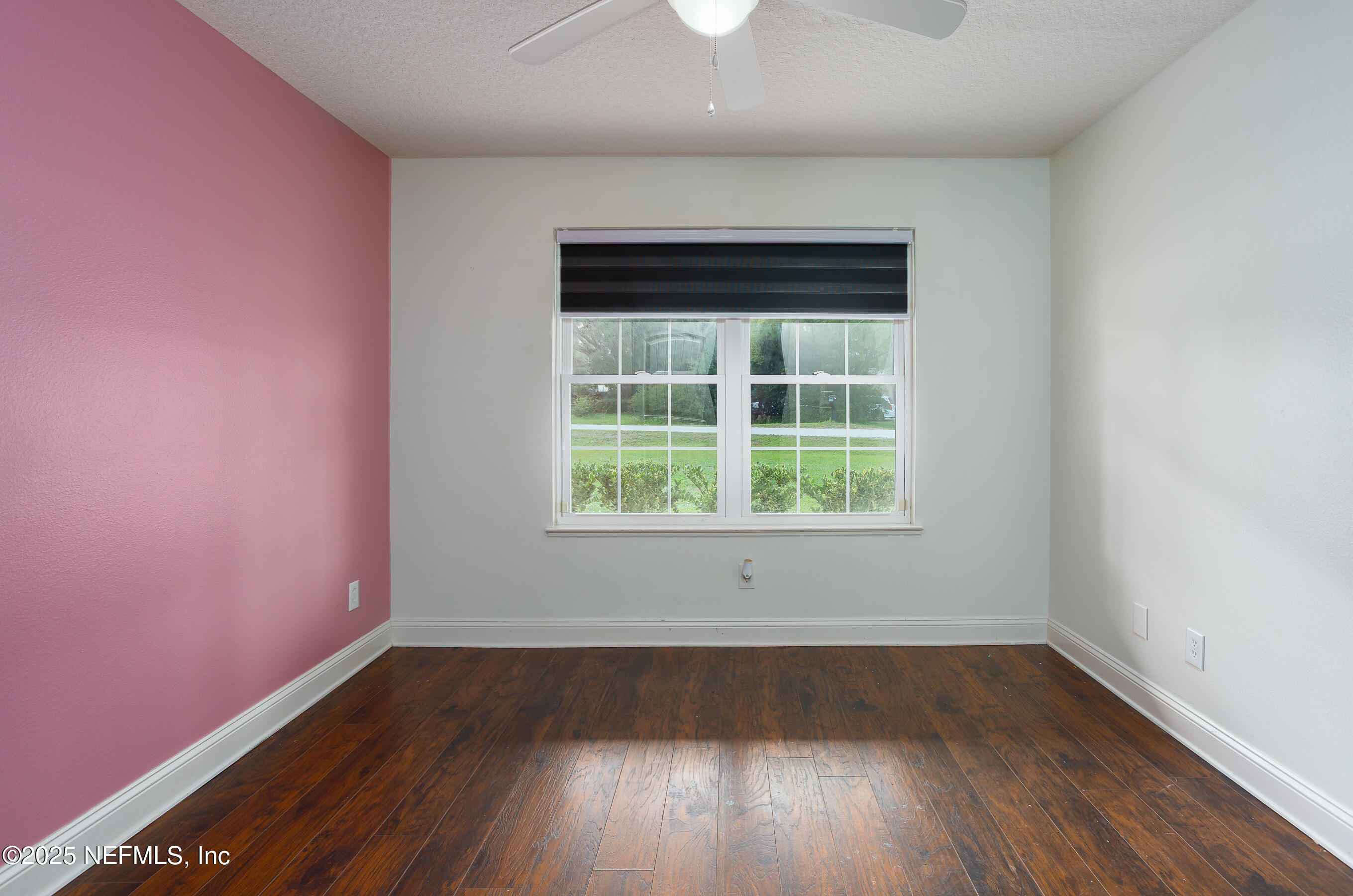 194 Horseman Club Road Palatka, FL 32177 - Photo 14 of 27 an empty room with wooden floor and windows