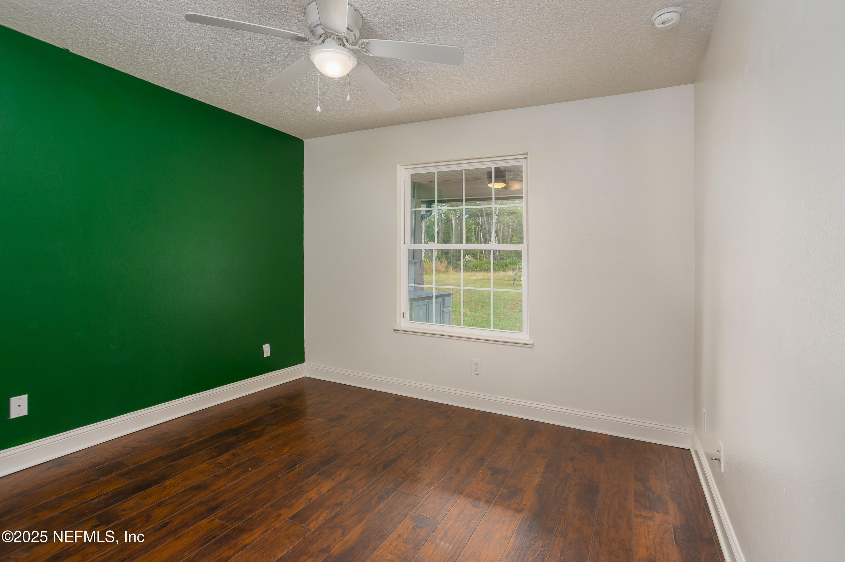 194 Horseman Club Road Palatka, FL 32177 - Photo 16 of 27 an empty room with wooden floor fan and windows