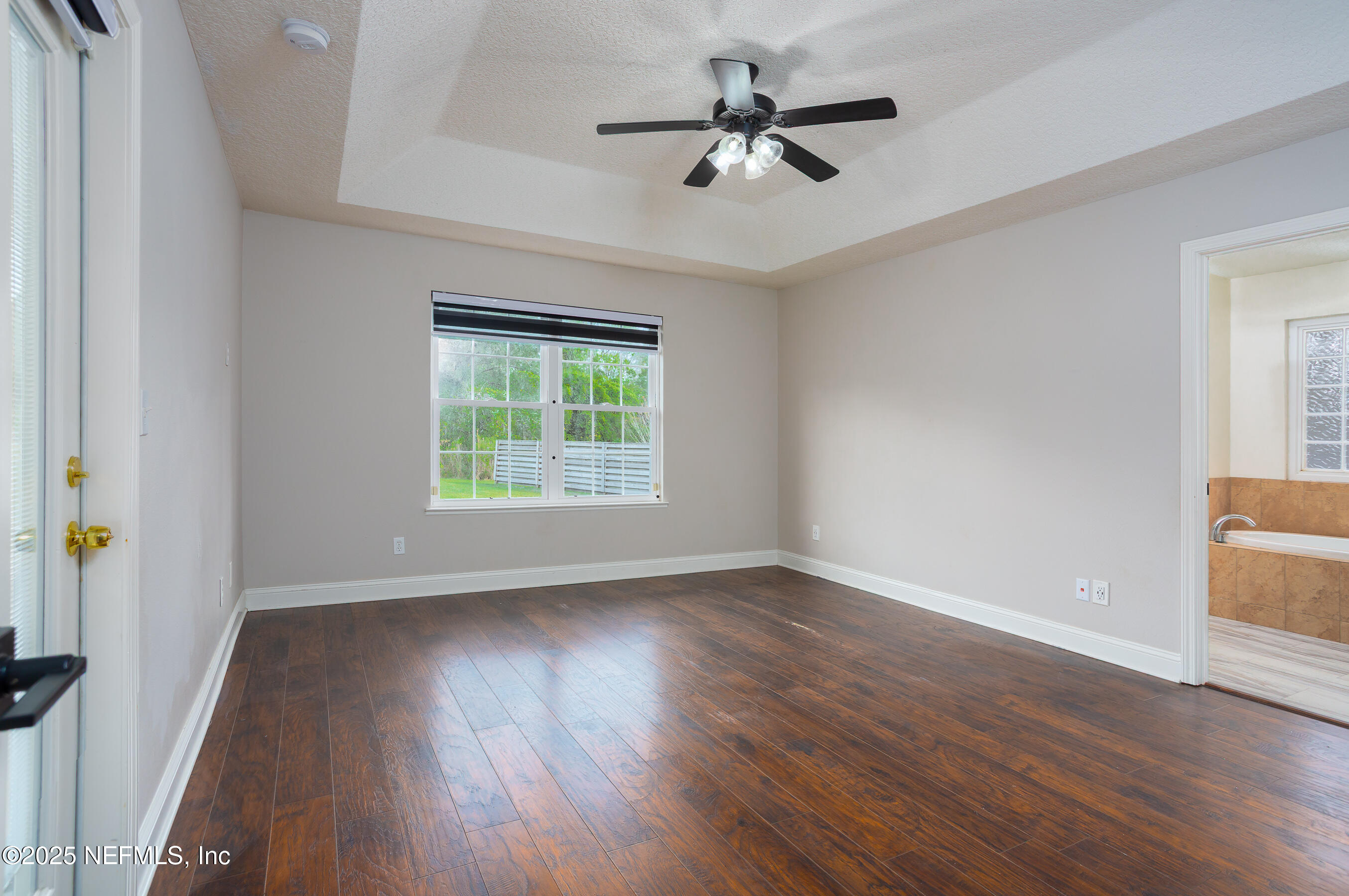 194 Horseman Club Road Palatka, FL 32177 - Photo 17 of 27 a view of an empty room with wooden floor and a window