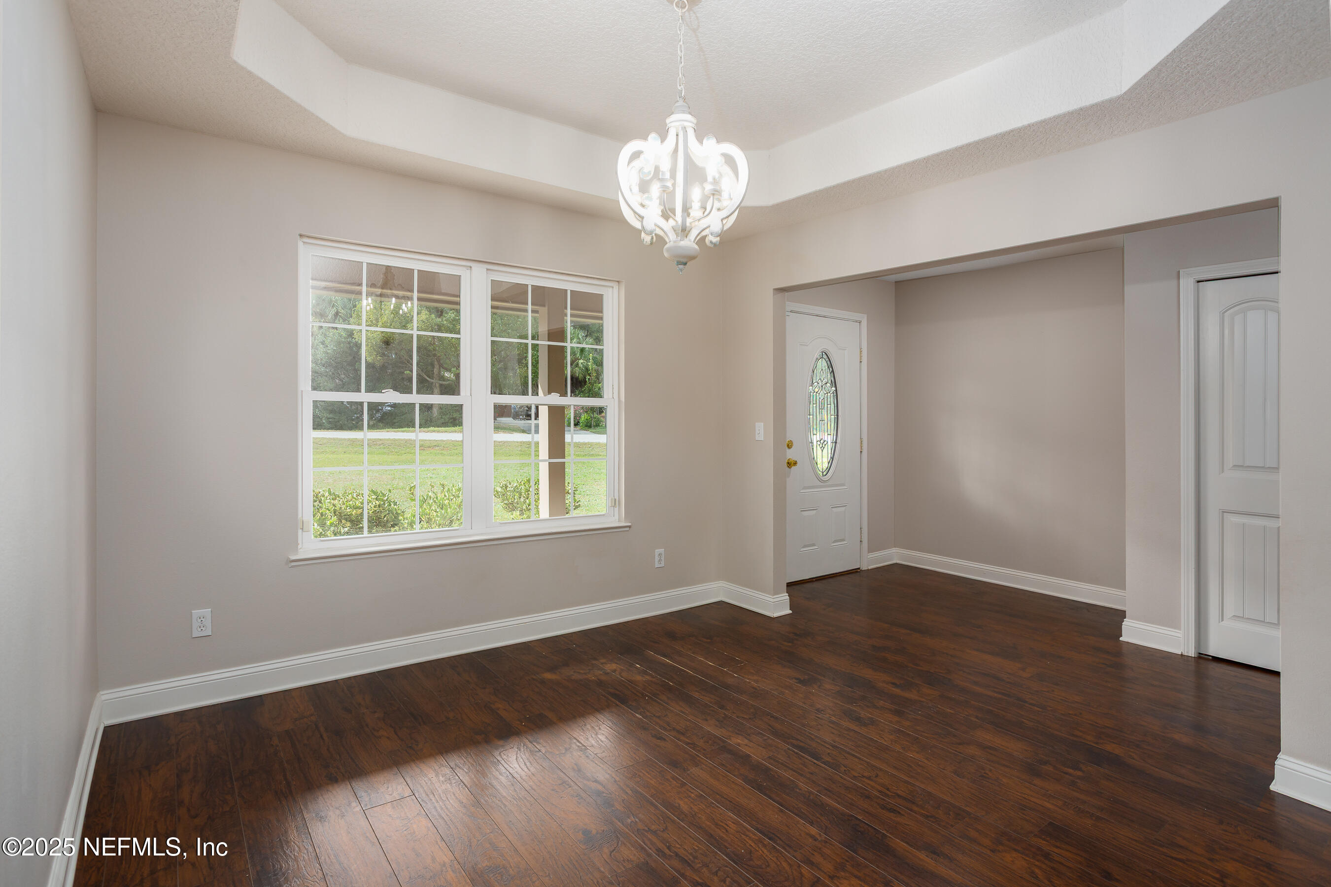 194 Horseman Club Road Palatka, FL 32177 - Photo 9 of 27 a view of an empty room with wooden floor and a window