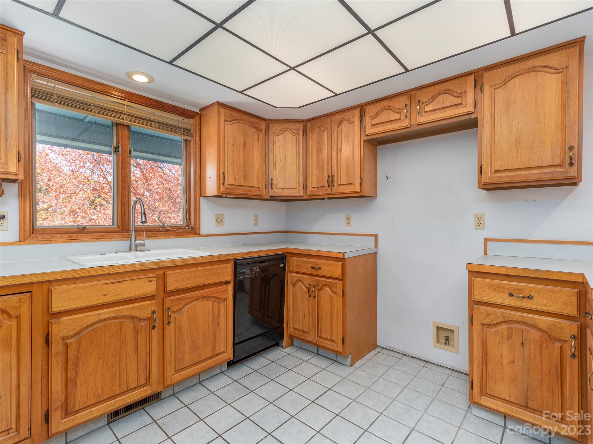 256 Goldfinch Lane Clyde, NC 28721 - Photo 12 of 31 a kitchen with stainless steel appliances granite countertop a sink window and cabinets