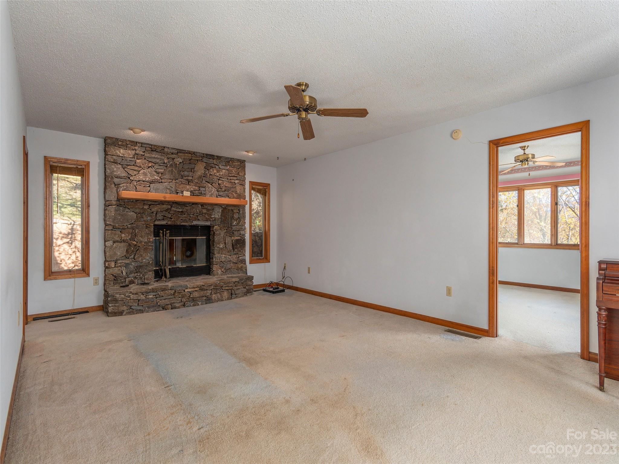 256 Goldfinch Lane Clyde, NC 28721 - Photo 4 of 31 an empty room with windows and fireplace