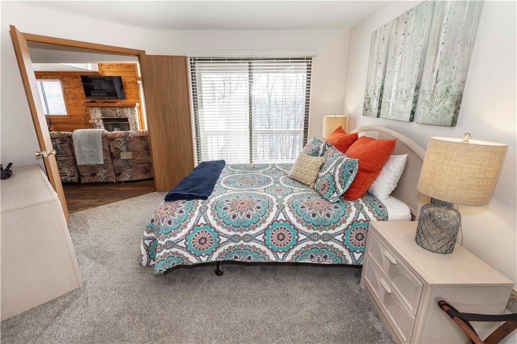 G11 Sunridge Road Champion, PA 15622 - Photo 23 of 30 a bedroom with a bed and wooden floor