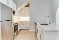 a kitchen with stainless steel appliances a refrigerator sink and cabinets