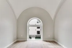 an empty room with a fireplace and window