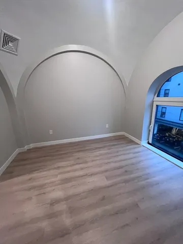 a room with a mirror and a wooden floor