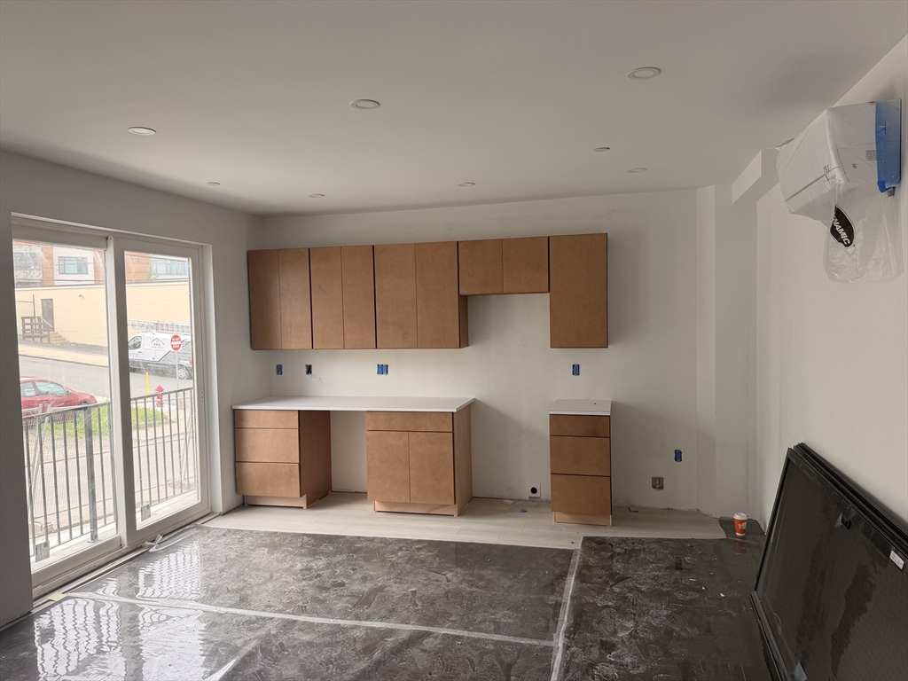 150 Williams Street, Unit 1 Chelsea, MA 02150 - Photo 6 of 7 a view of kitchen with wooden floor and electronic appliances
