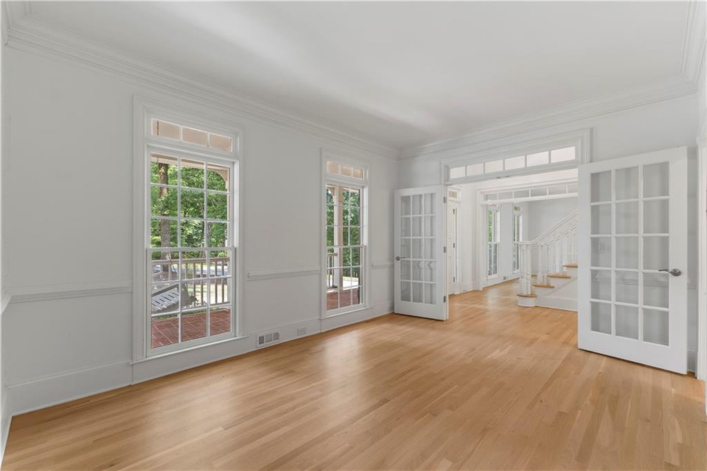 8965 Laurel Way Alpharetta, GA 30022 - Photo 22 of 79 an empty room with wooden floor and windows