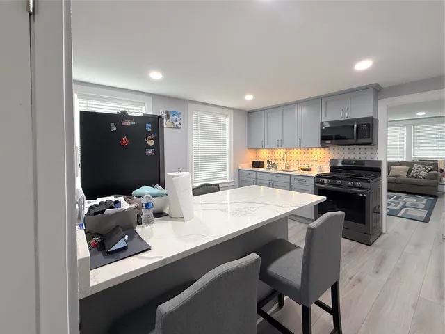a kitchen with a sink cabinets and refrigerator