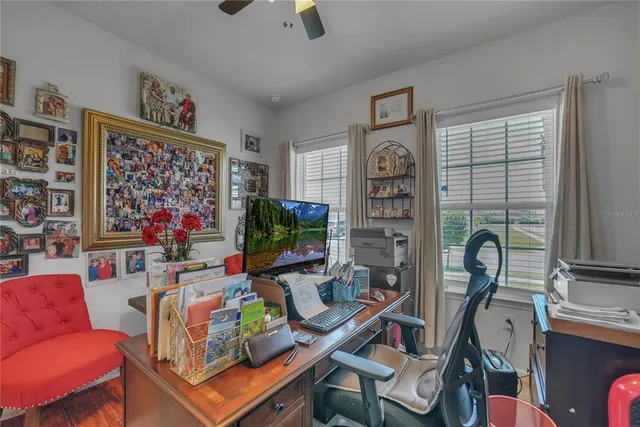 a spacious bedroom with a bed and a chandelier