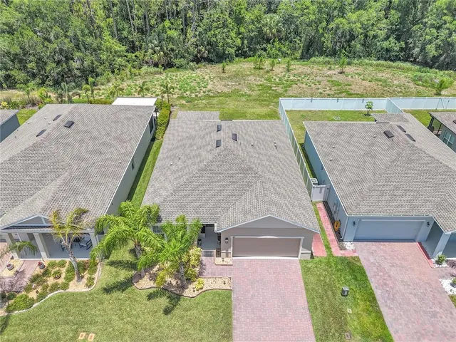 an aerial view of a house with a yard