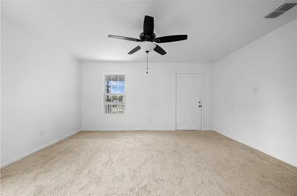 a view of room with a ceiling fan and window