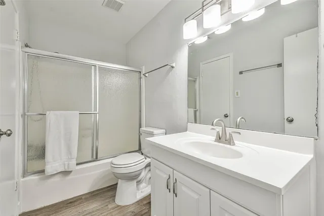 a bathroom with a sink toilet a mirror and shower