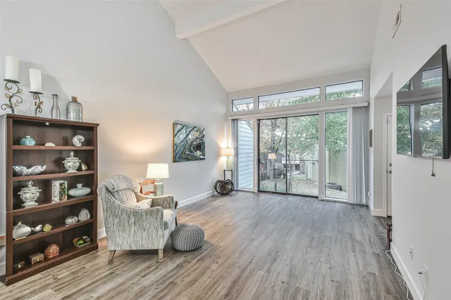 a view of a room with wooden floor and furniture