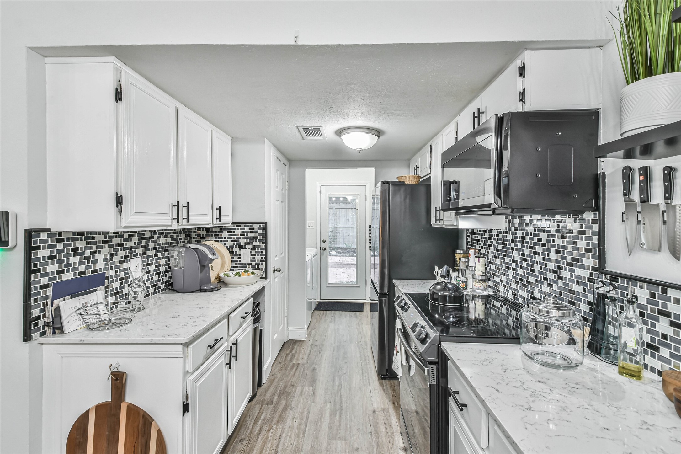 50 April Village Conroe, TX 77356 - Photo 5 of 19 a kitchen with a sink stove and refrigerator
