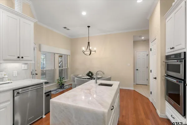 a kitchen with stainless steel appliances a sink stove and refrigerator