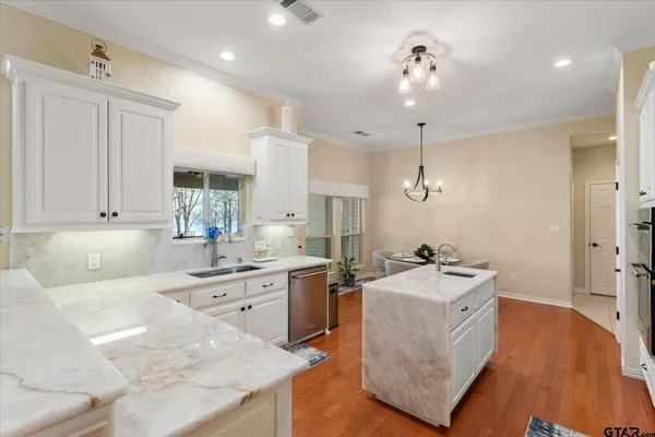 a kitchen with a sink appliances and cabinets