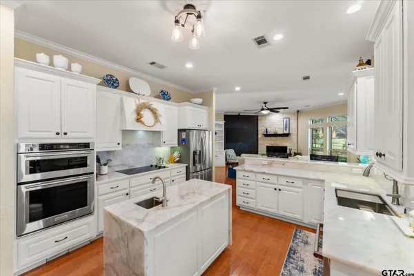 a kitchen with a sink stove and cabinets
