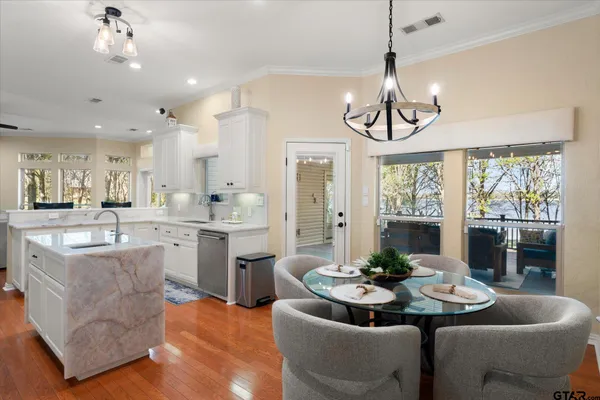 a dining room with furniture a chandelier and window