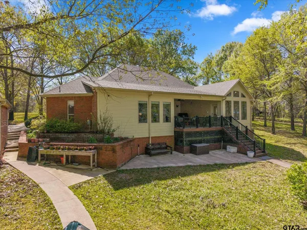 a view of a house with backyard and sitting area