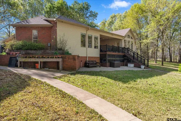 a view of house with a backyard