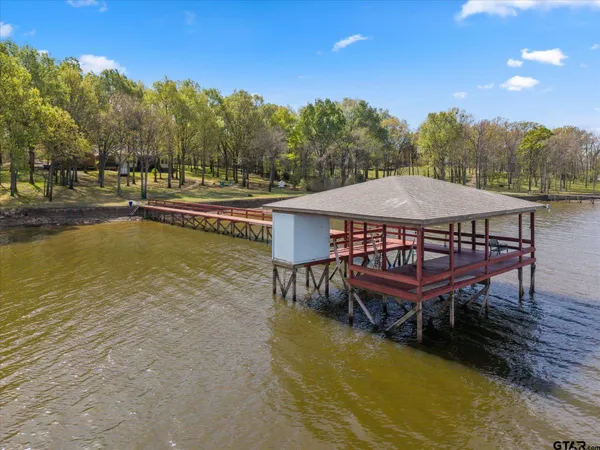 a view of a roof deck with wooden floor and lake view