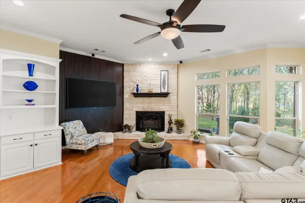 a living room with furniture fireplace and a large window