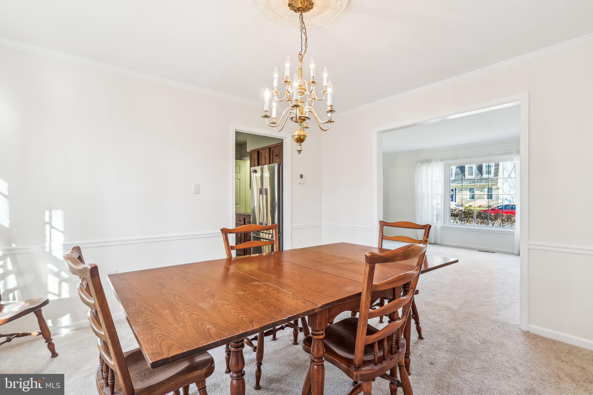 7122 Rolling Forest Avenue Springfield, VA 22152 - Photo 11 of 58 a view of a dining room with furniture and a chandelier