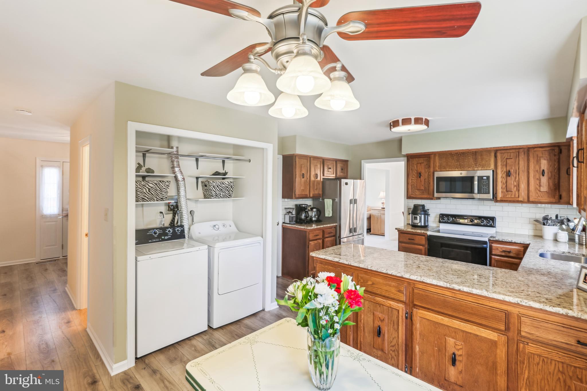 7122 Rolling Forest Avenue Springfield, VA 22152 - Photo 17 of 58 a kitchen with stainless steel appliances kitchen island granite countertop a stove and cabinets