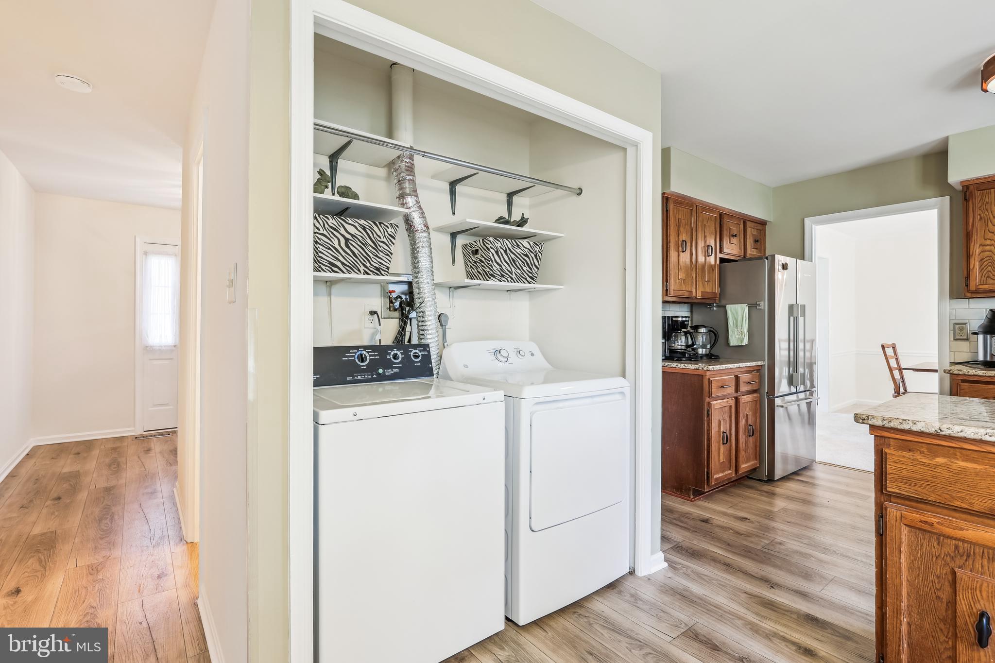 7122 Rolling Forest Avenue Springfield, VA 22152 - Photo 18 of 58 a kitchen with a refrigerator and cabinets