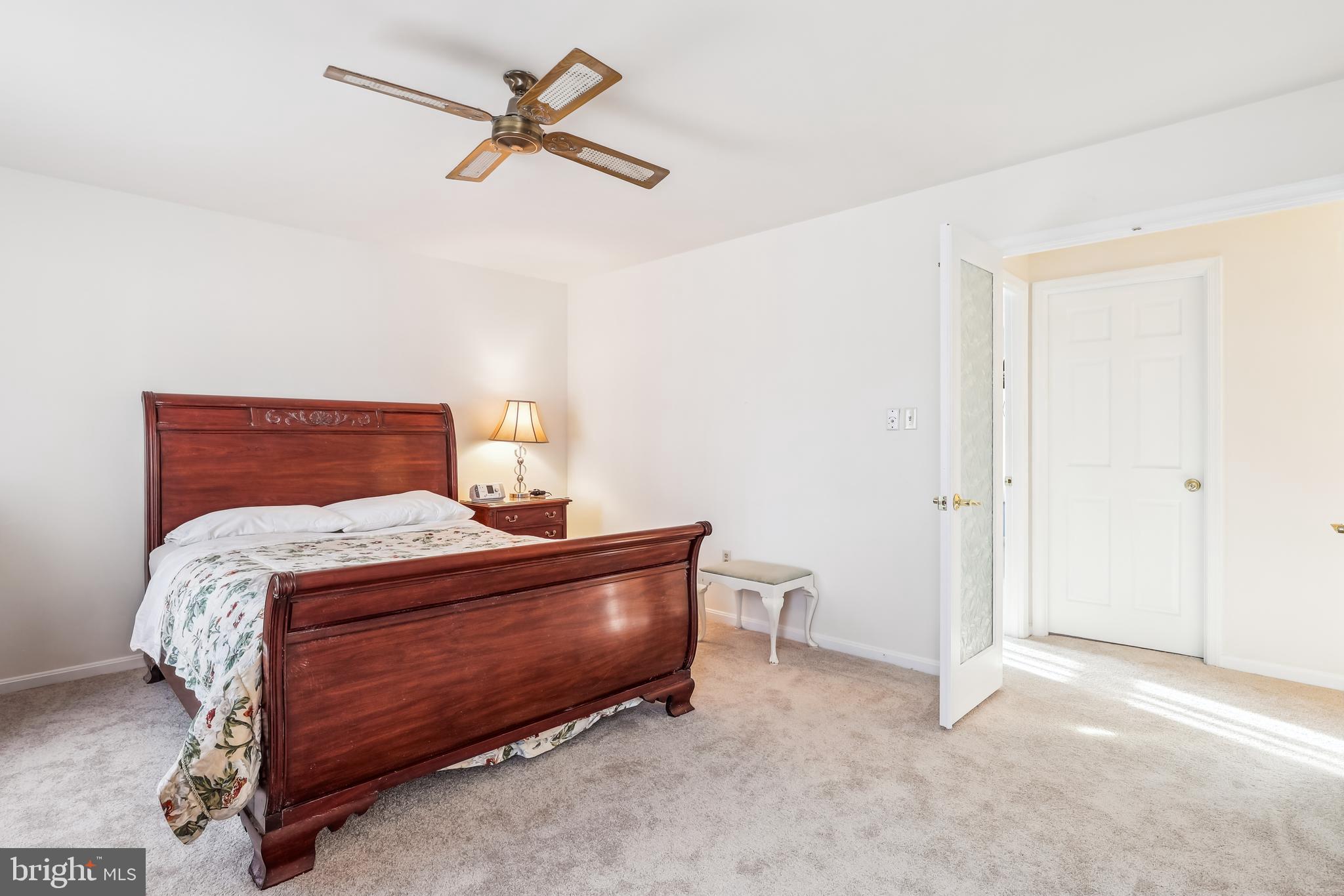 7122 Rolling Forest Avenue Springfield, VA 22152 - Photo 29 of 58 a bedroom with a bed and a ceiling fan