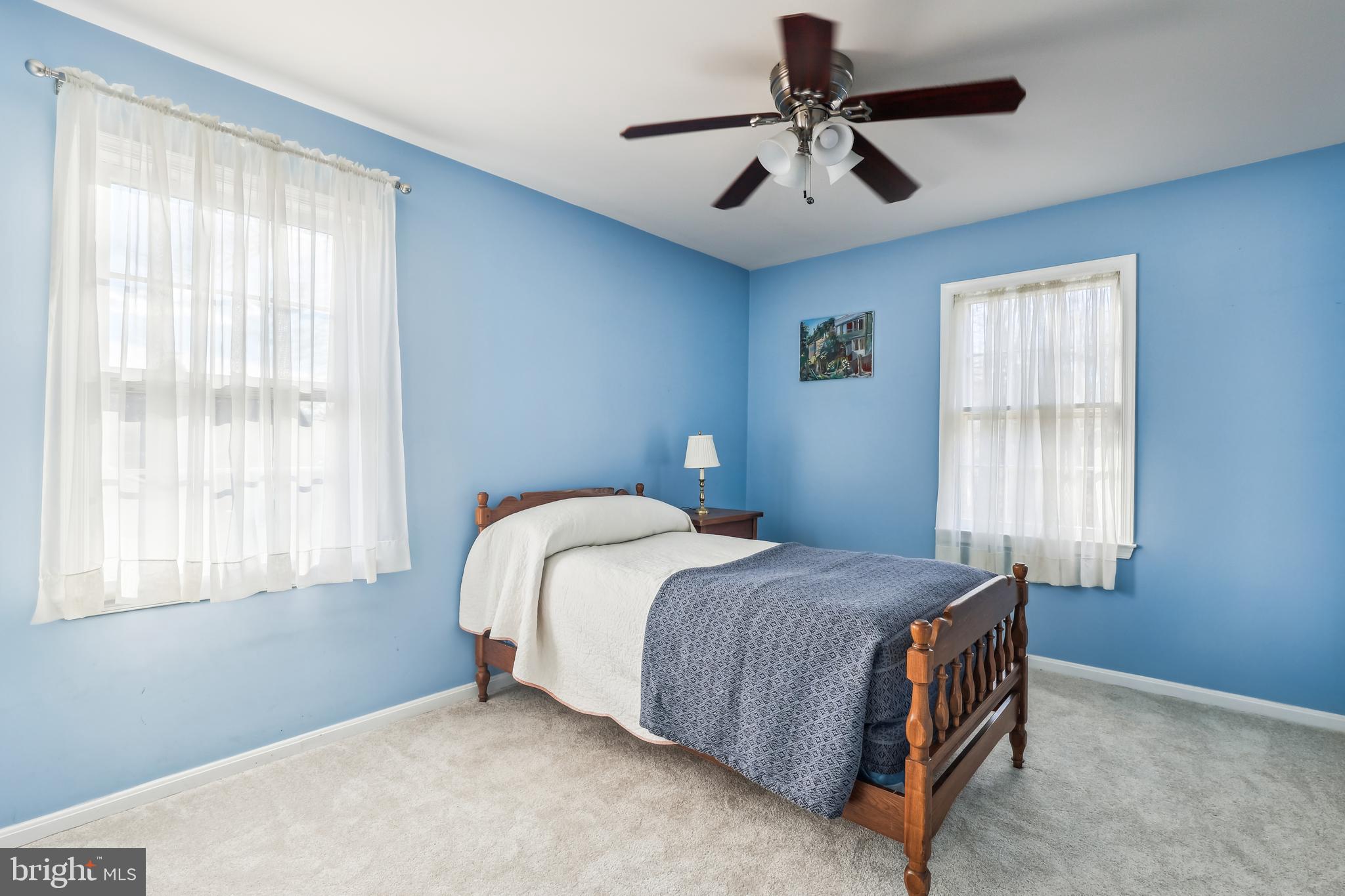 7122 Rolling Forest Avenue Springfield, VA 22152 - Photo 33 of 58 a bedroom with a bed and a chandelier