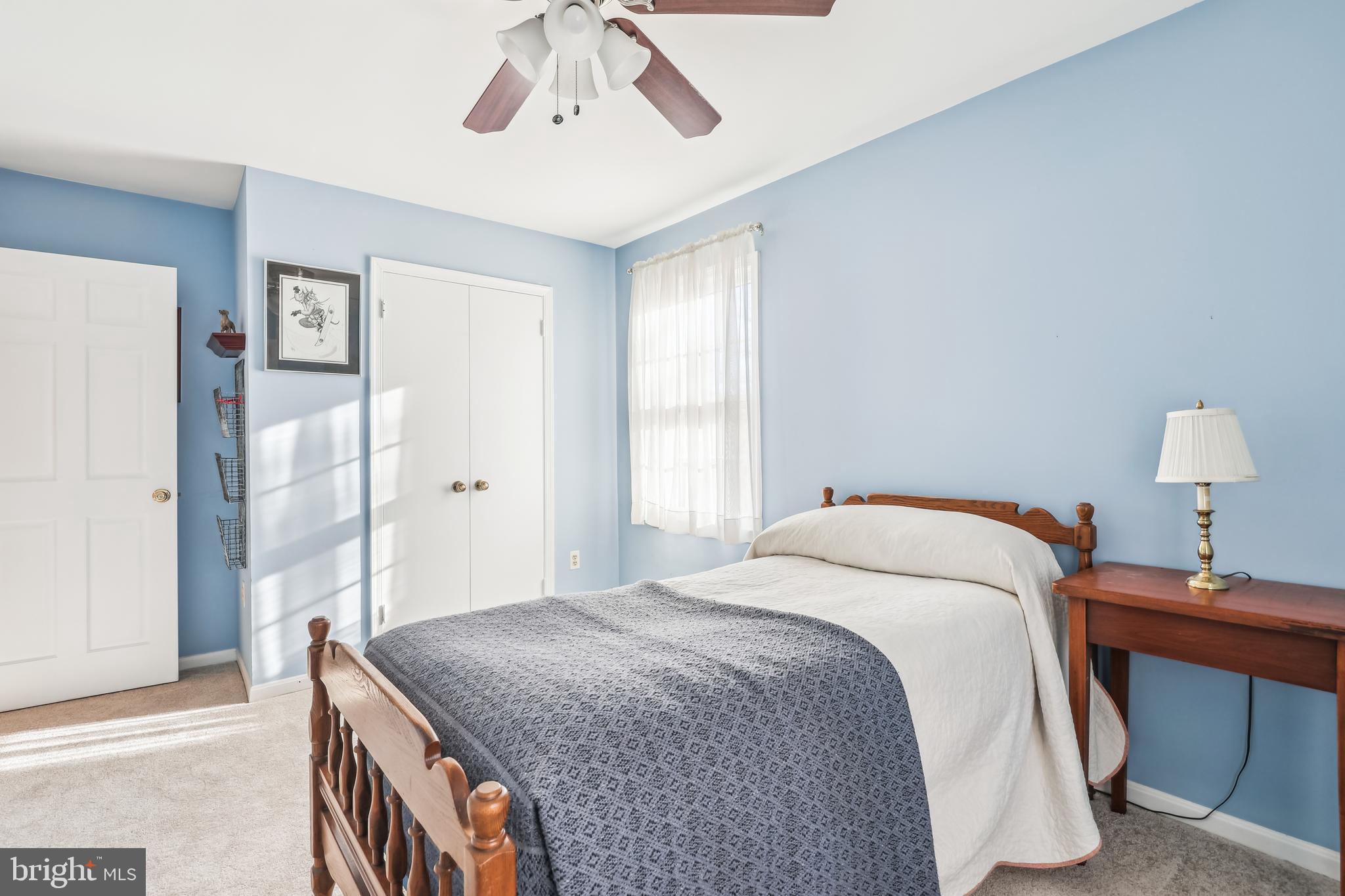 7122 Rolling Forest Avenue Springfield, VA 22152 - Photo 34 of 58 a bedroom with a bed and a chandelier